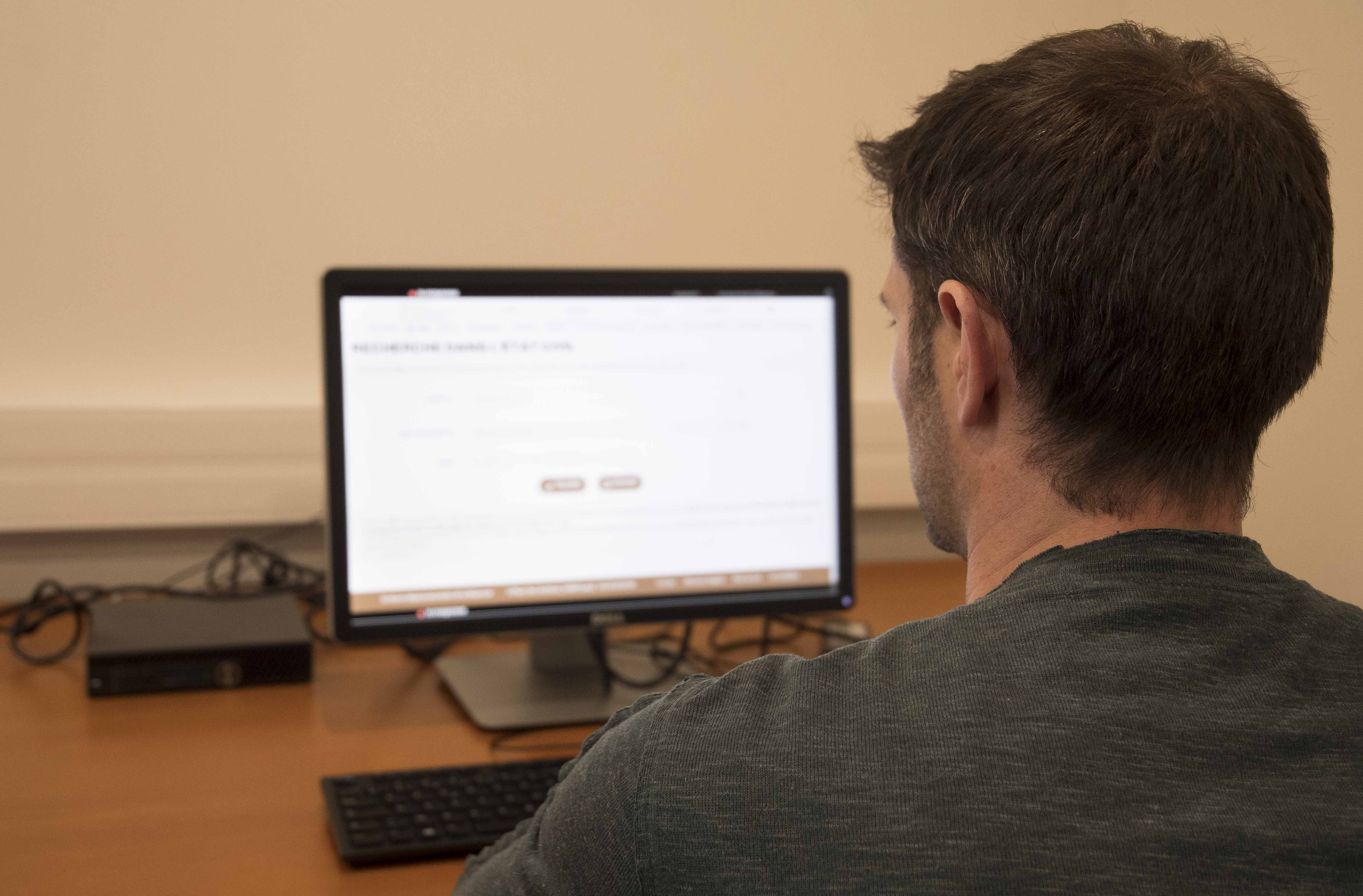 Personne utilisant le site internet des archives sur un ordinateur